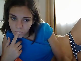 Amateur nubile with her small tits poses nearly bare in front of her webcam.